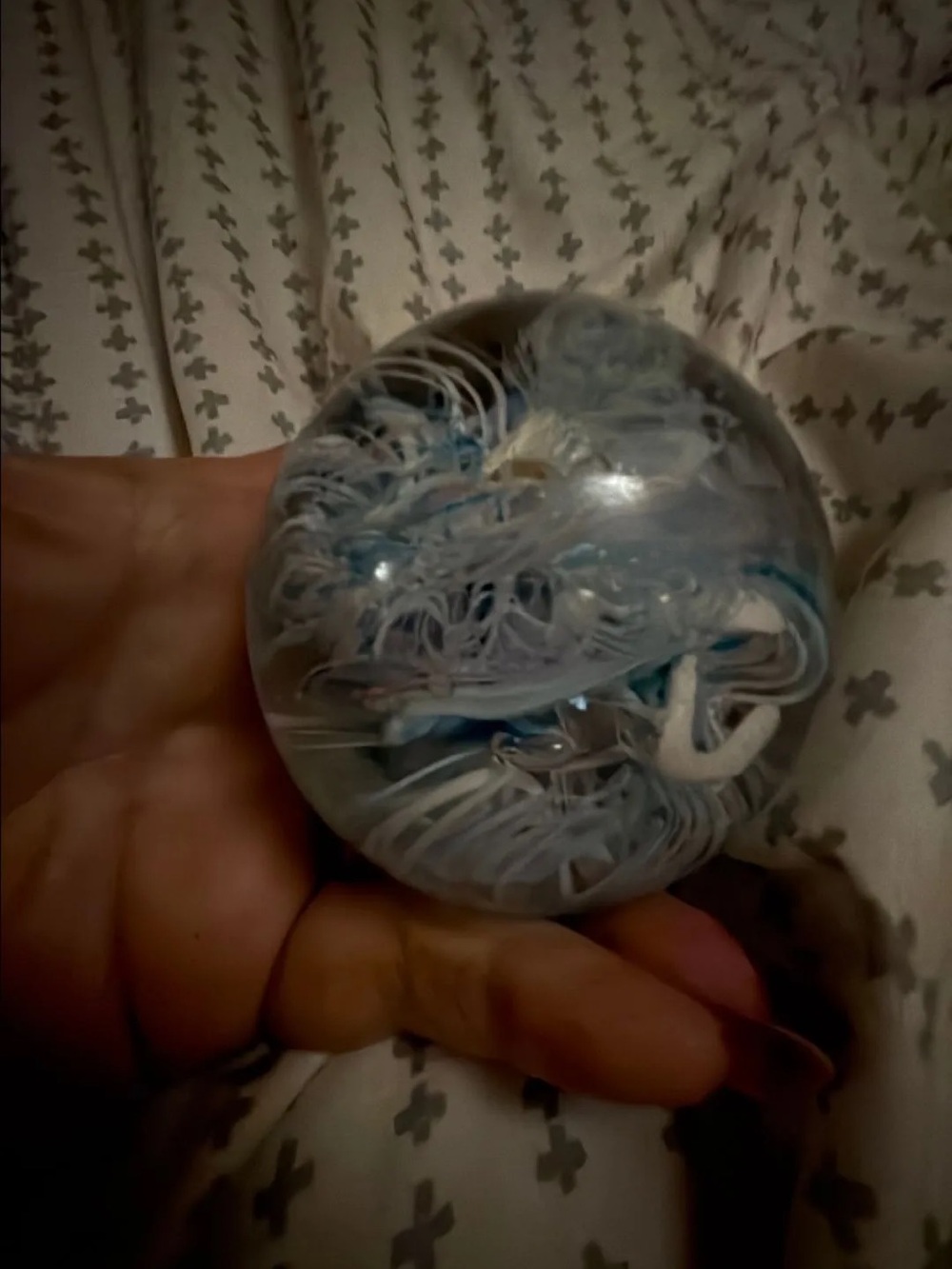 Handheld Glass Orb Paperweight with Blue and White Swirl